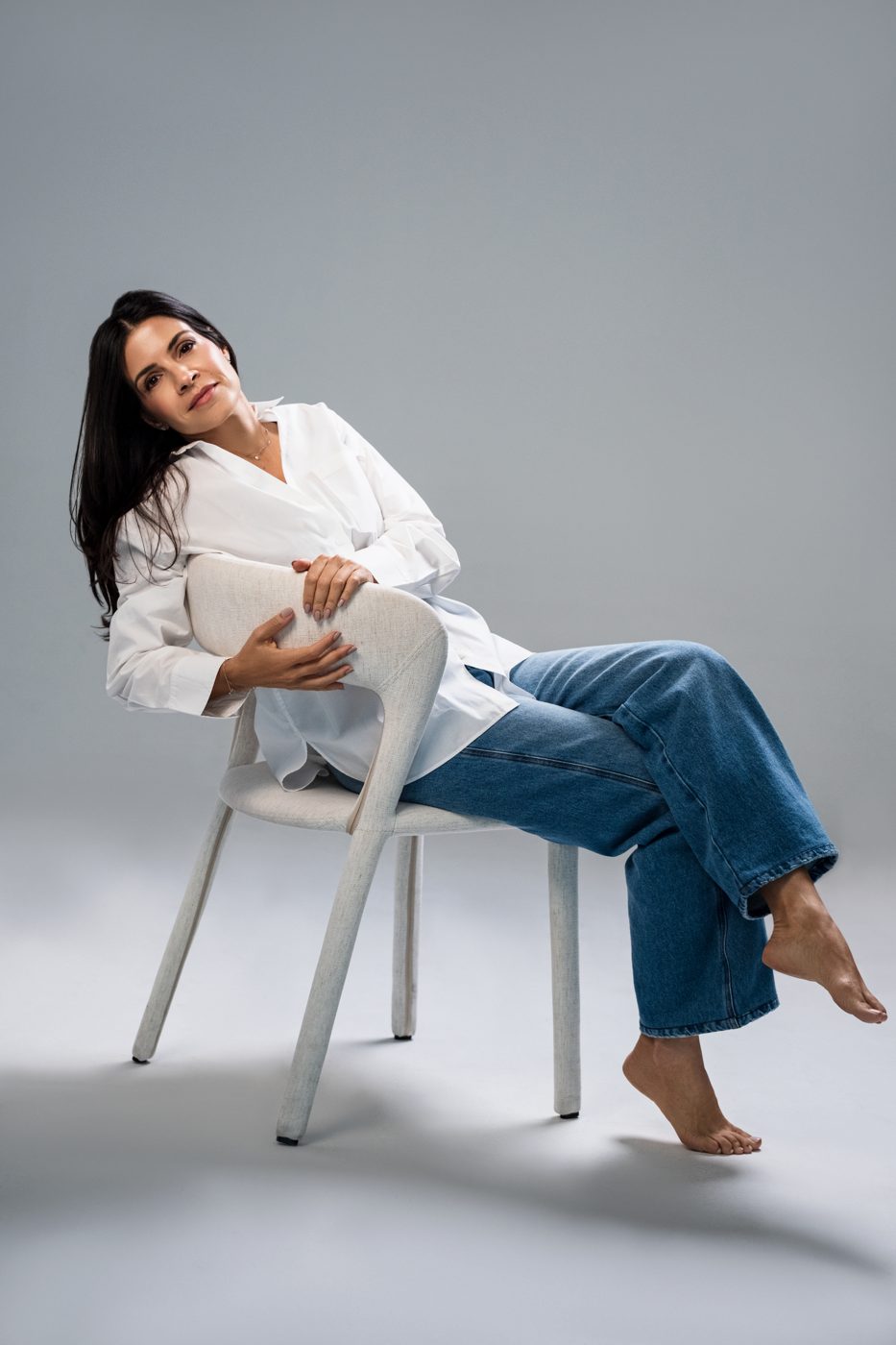 Marina sitting relaxed on a chair
